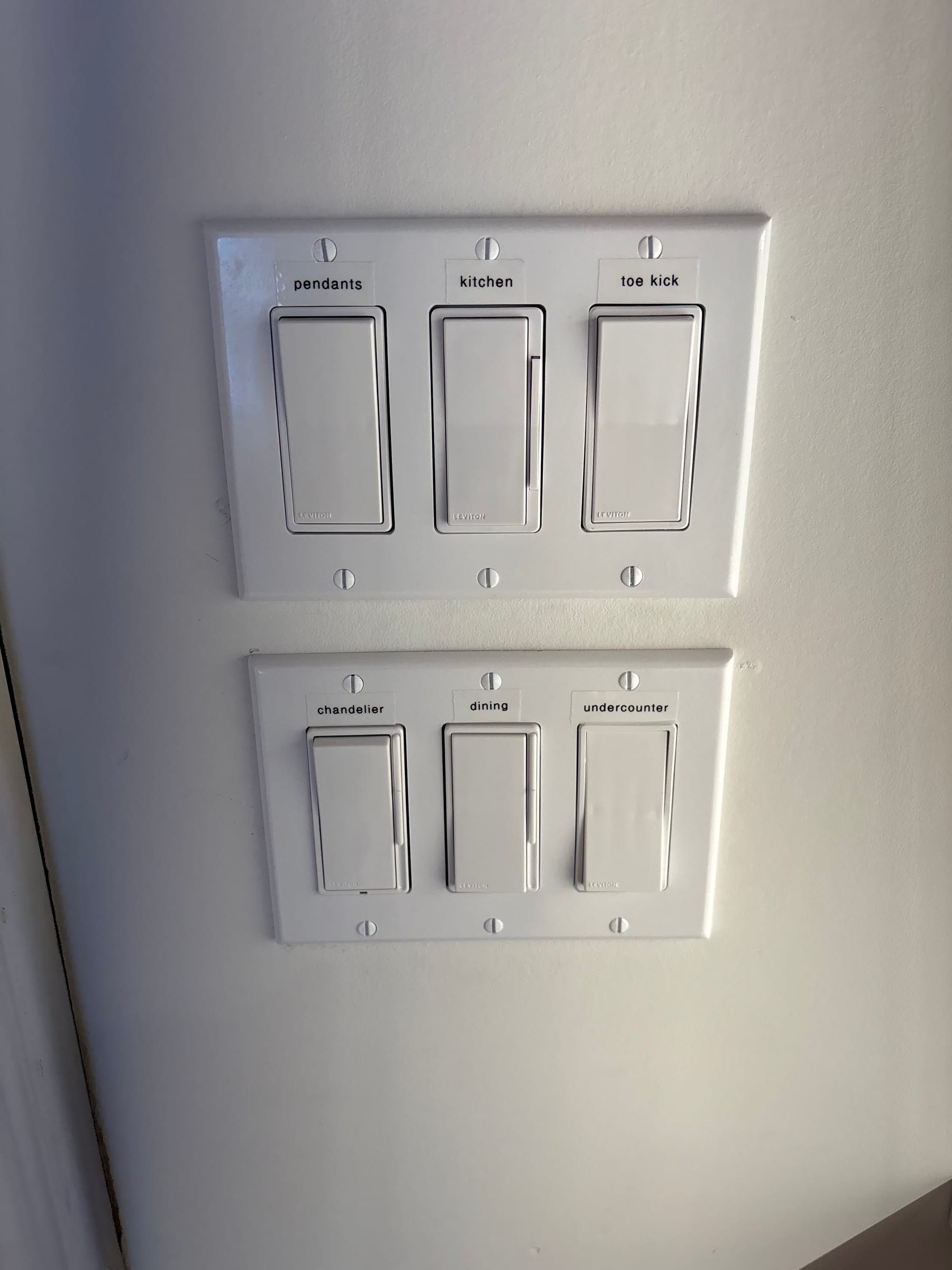 Custom-labeled dimmer switches for pendants, kitchen and chandelier by Call Paul Contracting in Edmonton