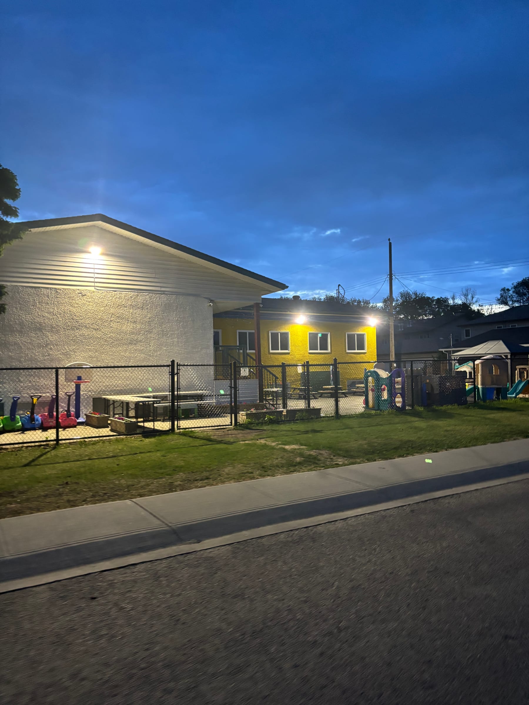 Commercial exterior and site lighting at a daycare at dusk by Call Paul Contracting near Edmonton