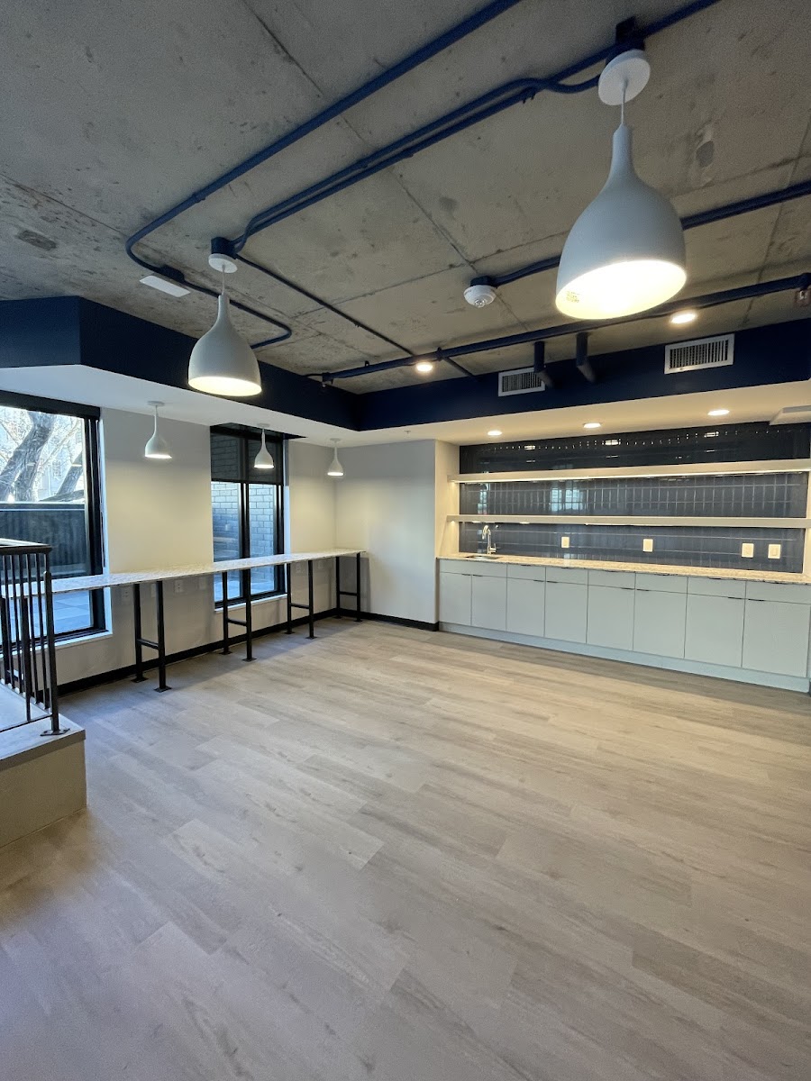 Commercial fit-out with exposed-ceiling conduit, dome pendants and feature lighting