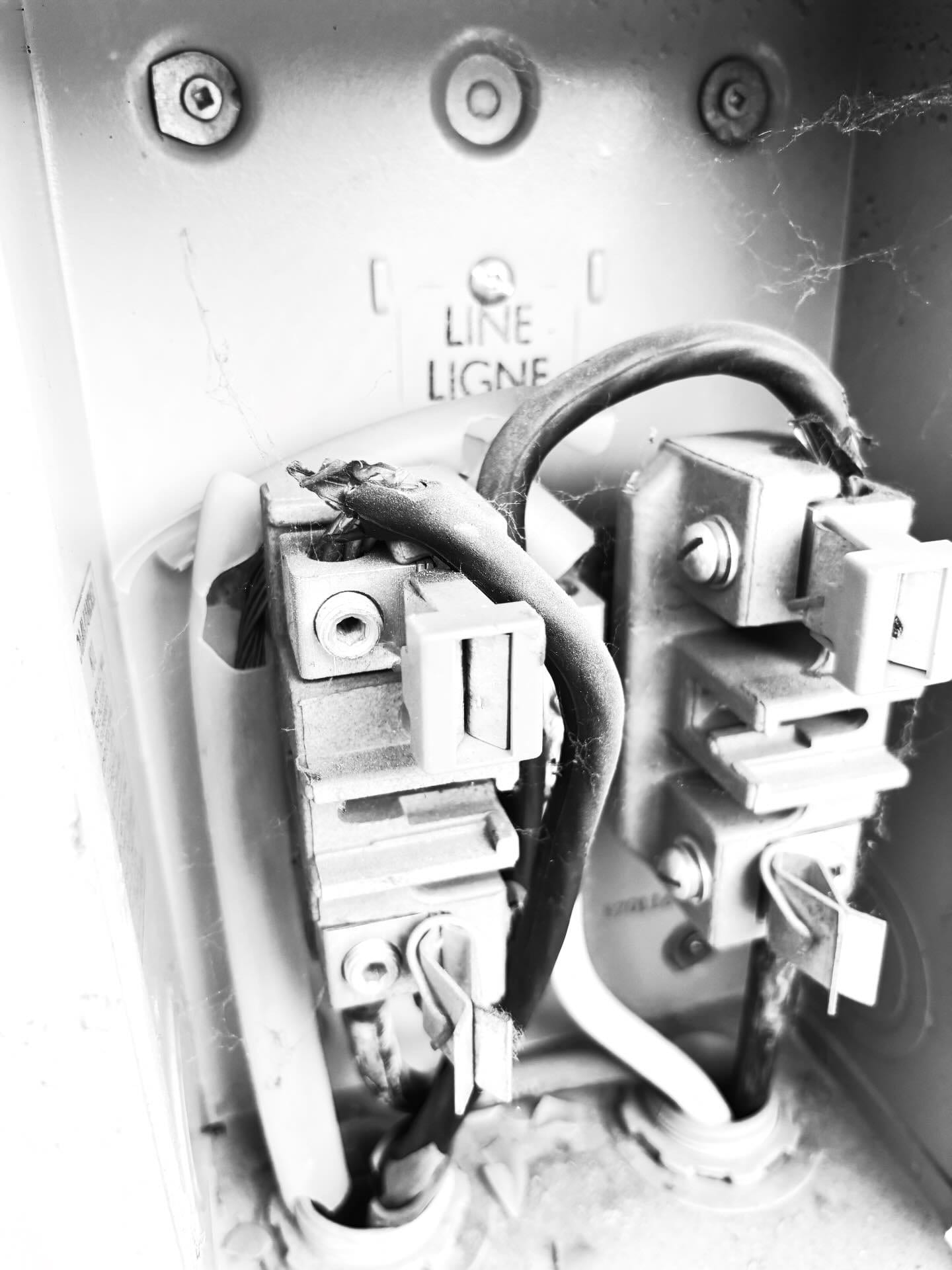 Burnt and damaged service conductors found at a meter base during a safety inspection by Call Paul Contracting, Edmonton