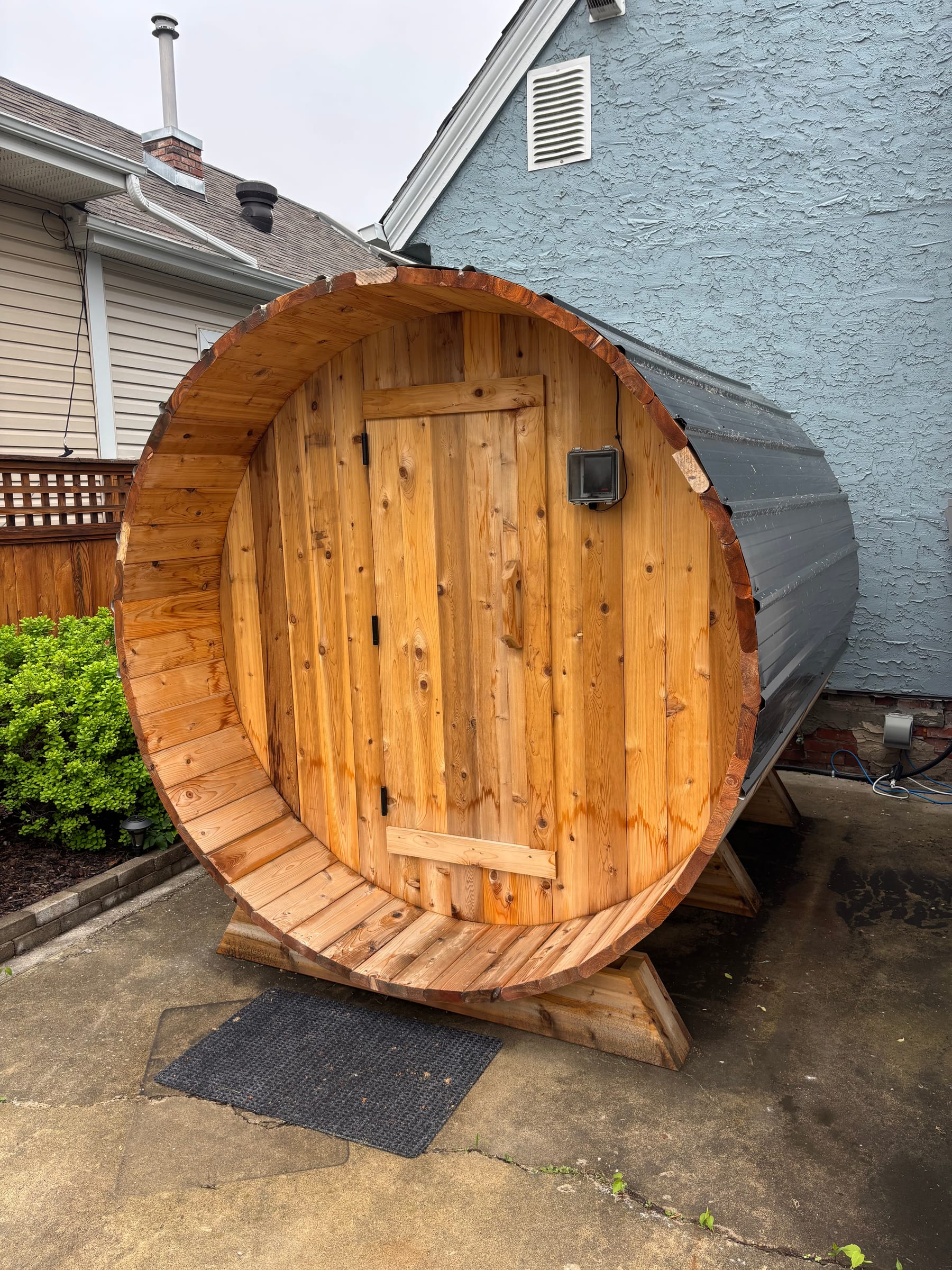 Outdoor cedar barrel sauna wired and powered by Call Paul Contracting in Edmonton