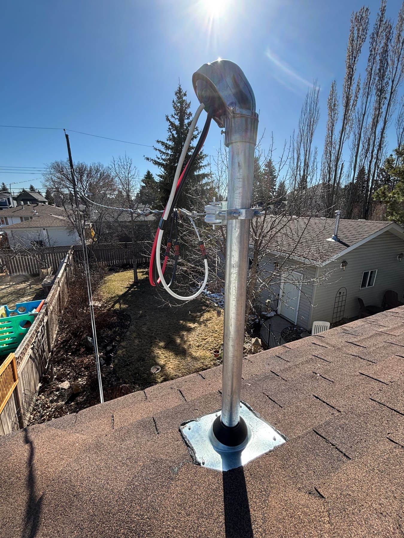 Electrical service mast and weatherhead upgrade on a roof by Call Paul Contracting, Edmonton